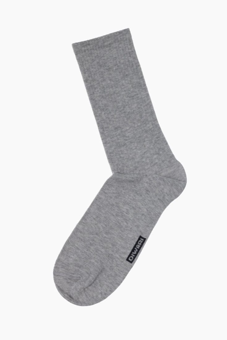 A grey crew-length sock with a ribbed cuff and a small rectangular logo tag on the side.