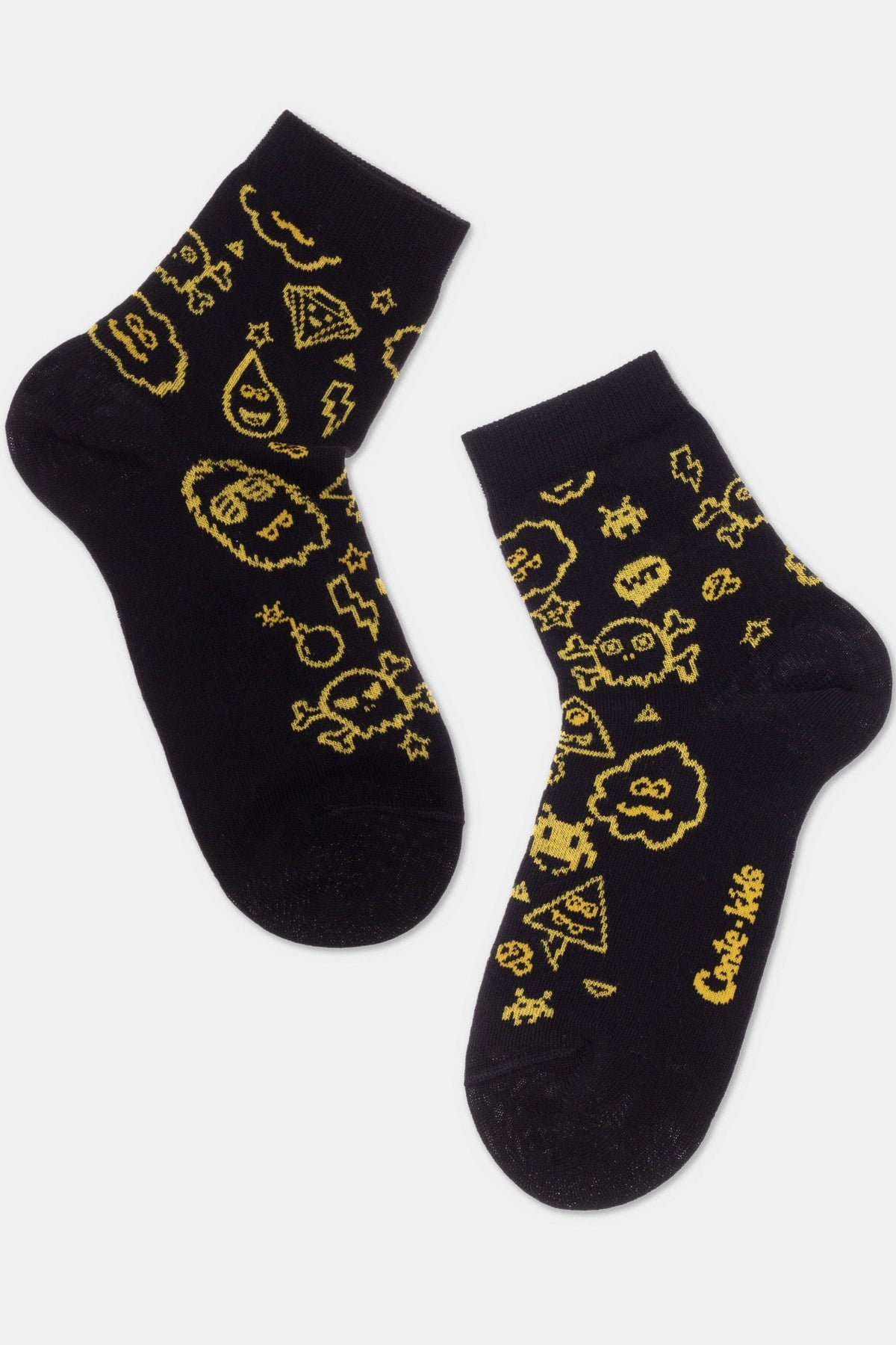 A pair of black ankle socks featuring a yellow repeating pattern of various pixelated icons including skulls, lightning bolts, clouds, and diamonds.