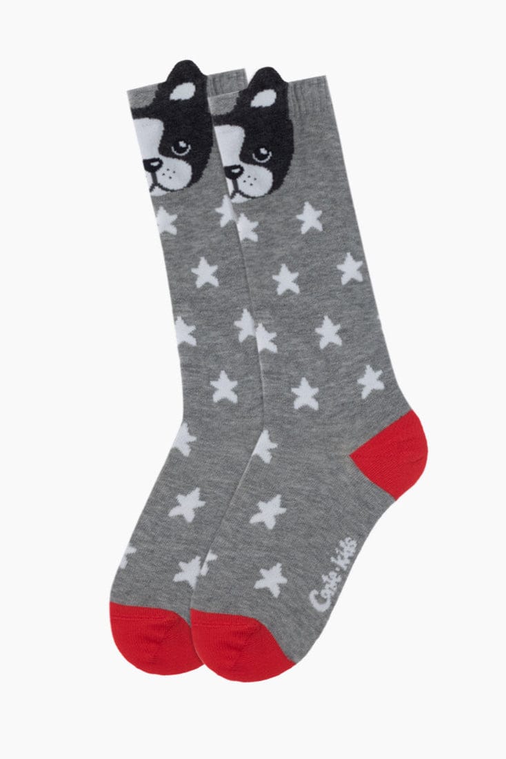 A pair of grey crew socks featuring a repeating white star pattern, a black and white dog face detail at the top, and solid red heels and toes.