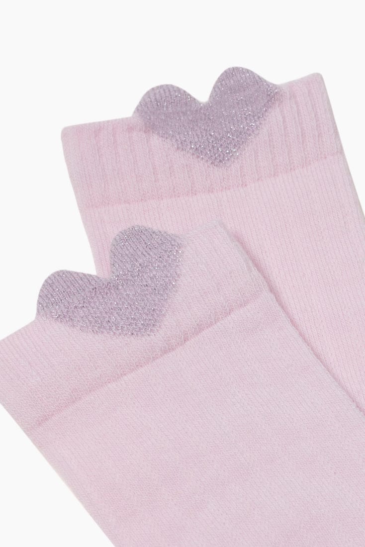 A pair of light pink socks featuring a decorative glittery lilac heart detail on the top cuff of each sock.