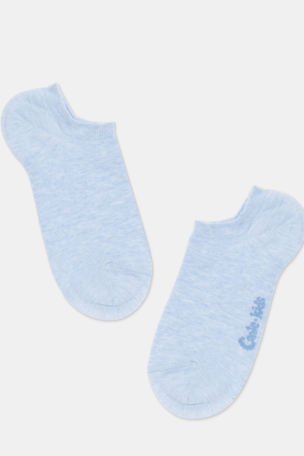 A pair of light blue ankle socks with a subtle heathered texture and the words Cote Kids written in small dark blue font on the side of one sock.