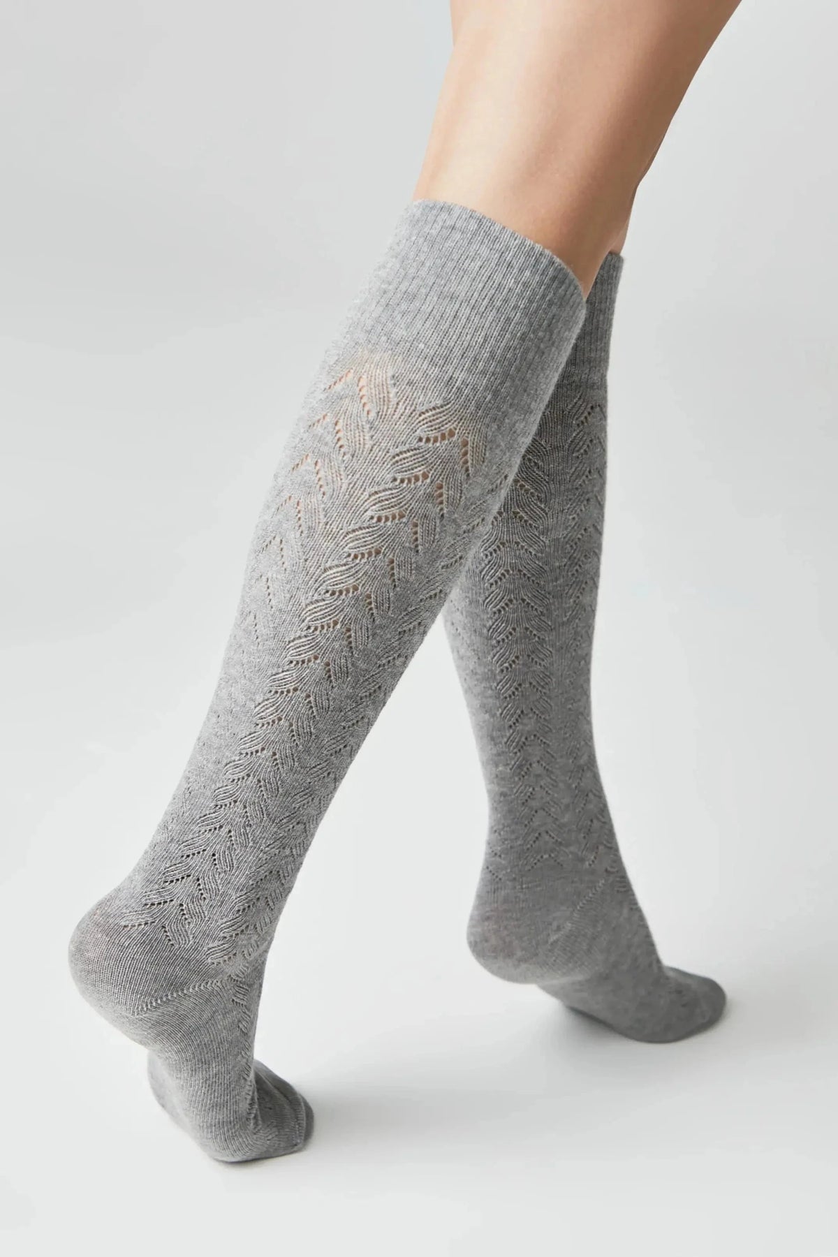 Grey knee-high socks with a delicate vertical chevron pointelle pattern on the legs and a smooth knit finish on the heels and toes.