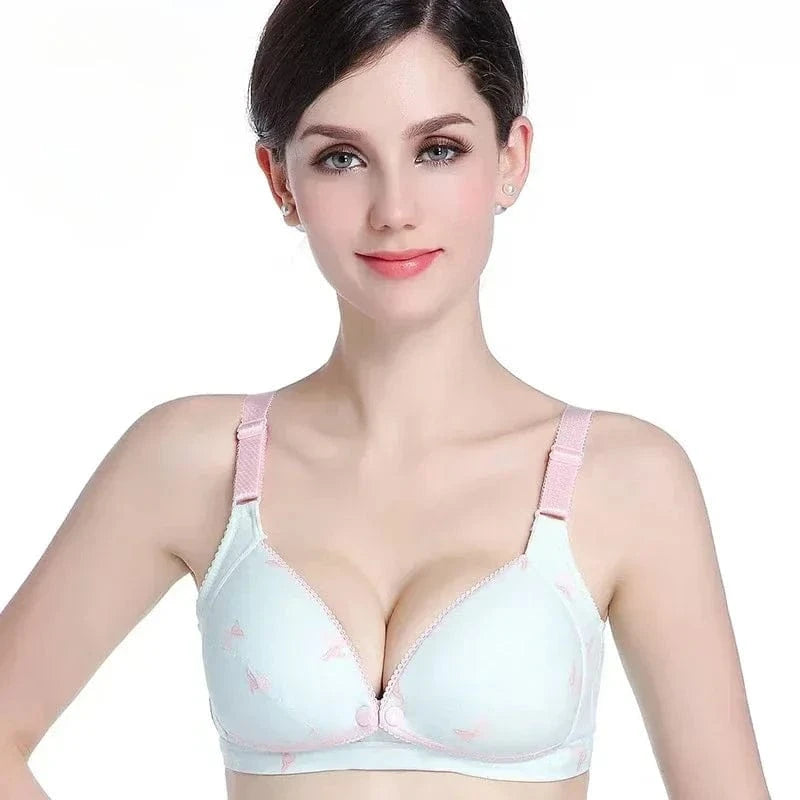 A woman wearing a light blue, lightly padded bra with pink butterfly prints and pink adjustable shoulder straps.