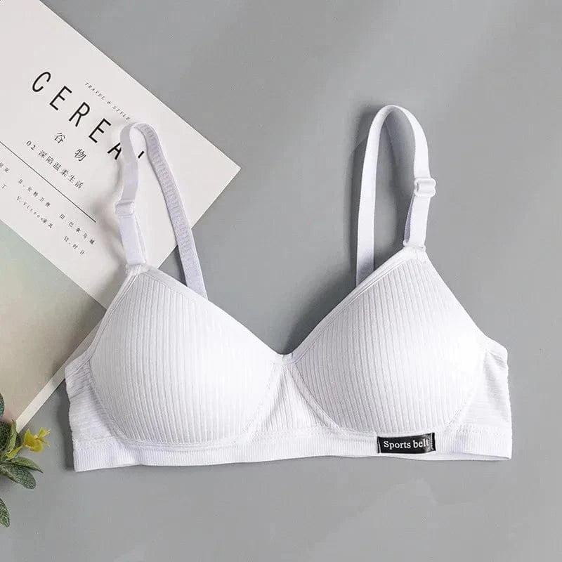 A white ribbed wireless bralette with adjustable straps and a small black rectangular tag labeled Sports belt on the bottom right band.