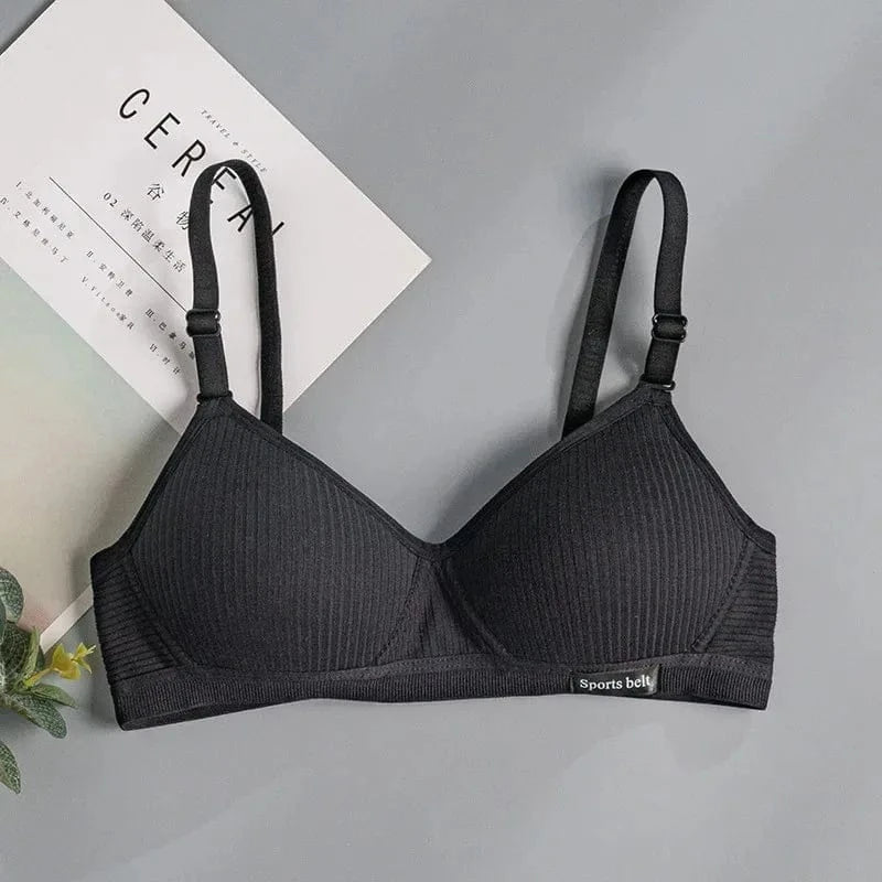 A black wireless sports bra featuring a ribbed texture, adjustable shoulder straps, and a small tag on the front band labeled Sports belt.