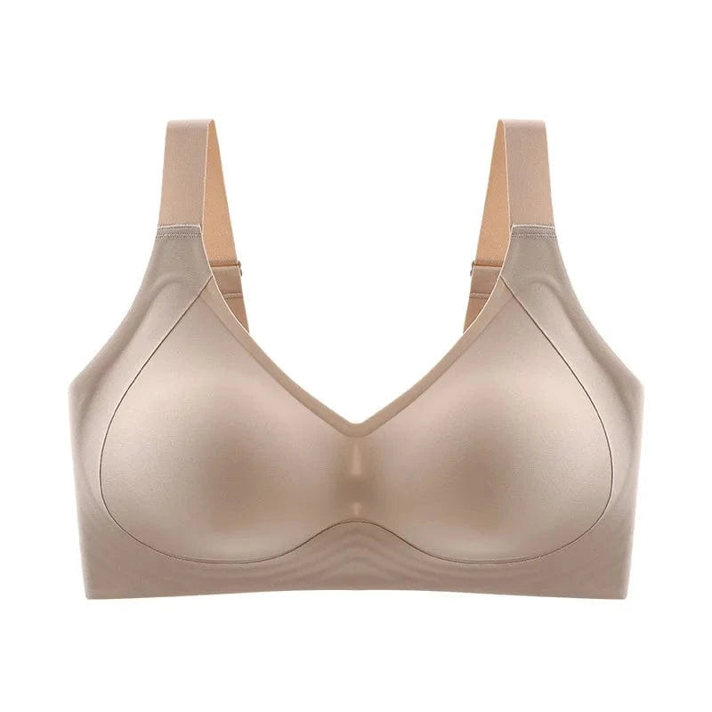 A beige wireless bra featuring wide straps and smooth, molded cups in a clean studio setting.