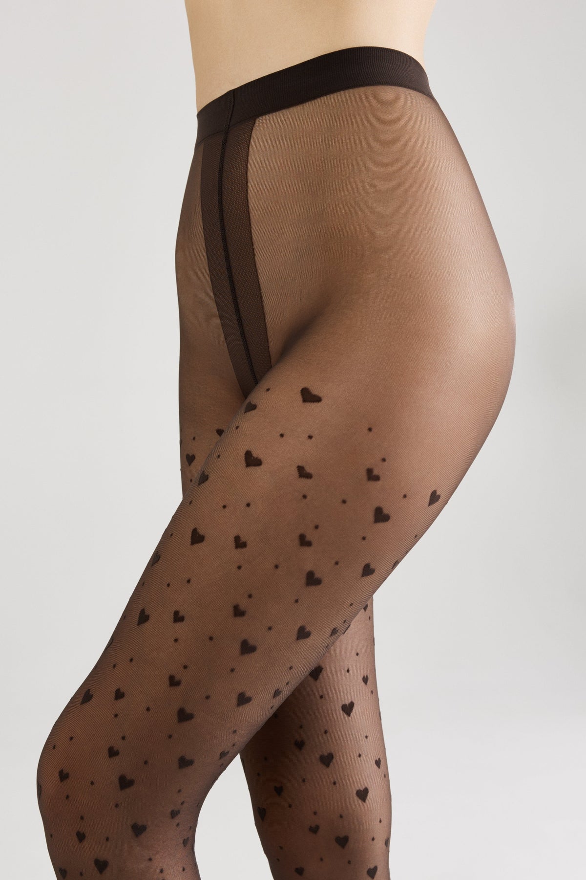 Sheer black pantyhose featuring a recurring pattern of small black hearts against a solid light background.