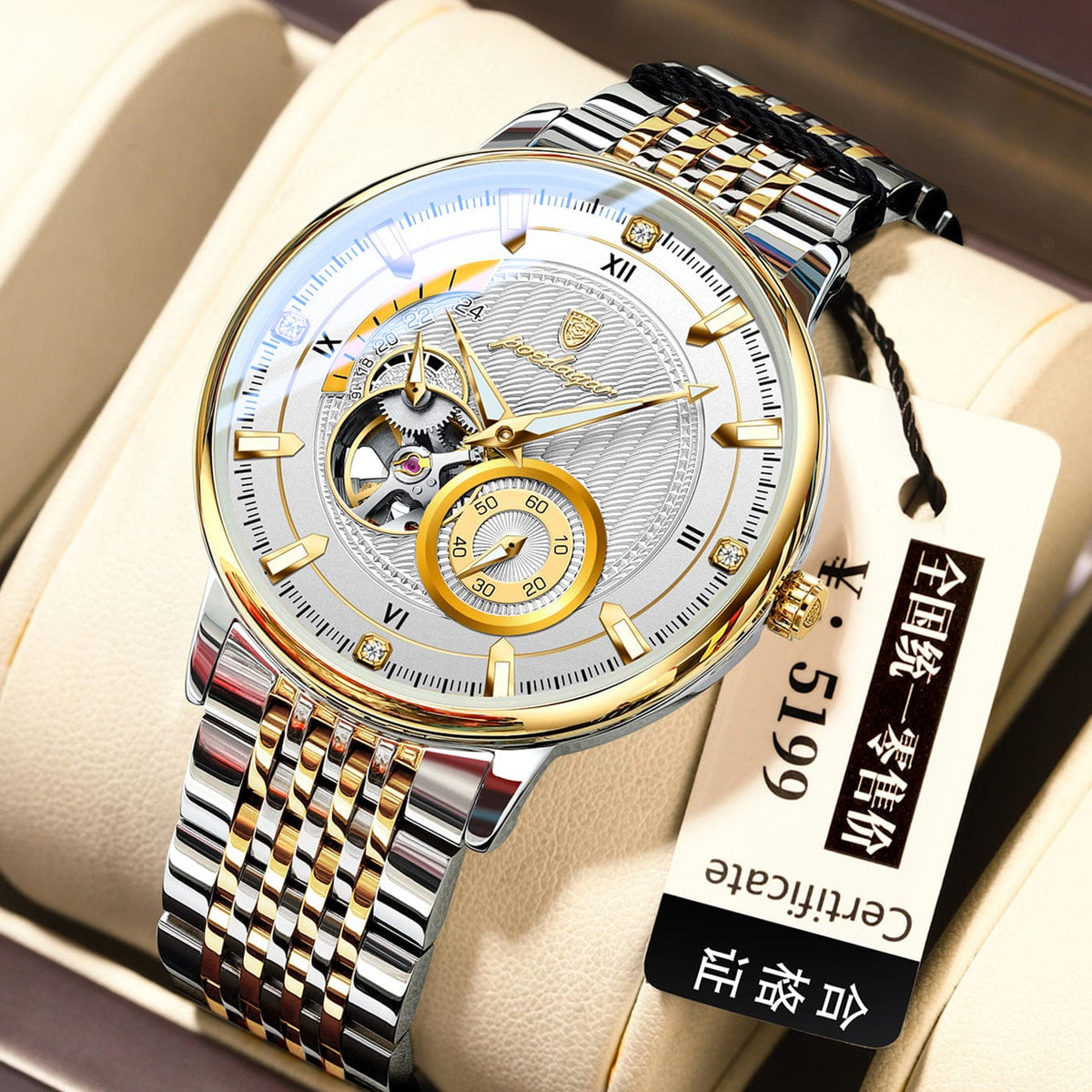 A round mechanical wristwatch with a white textured dial, gold-tone hour markers, and a two-tone silver and gold stainless steel link bracelet sitting on a cream-colored watch cushion.