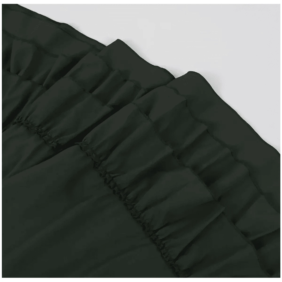 A close-up of a dark green fabric garment featuring multiple tiers of gathered ruffles.