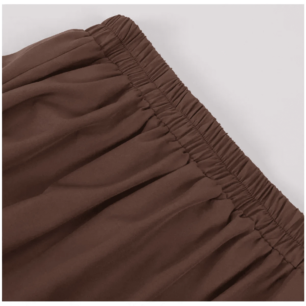 A close-up view of the brown elasticized waistband on a garment, showing the gathered fabric texture.