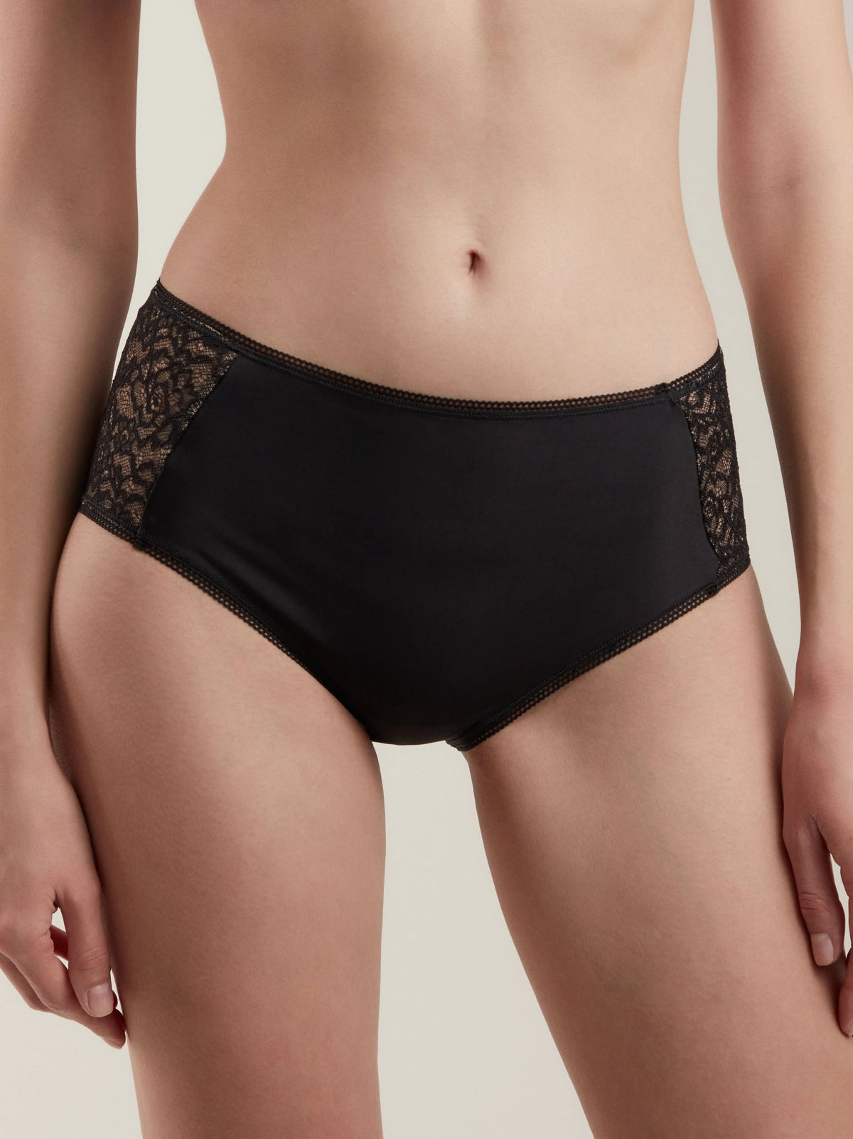 Black high-cut panties featuring lace side panels and a delicate scalloped trim along the waistband and leg openings.