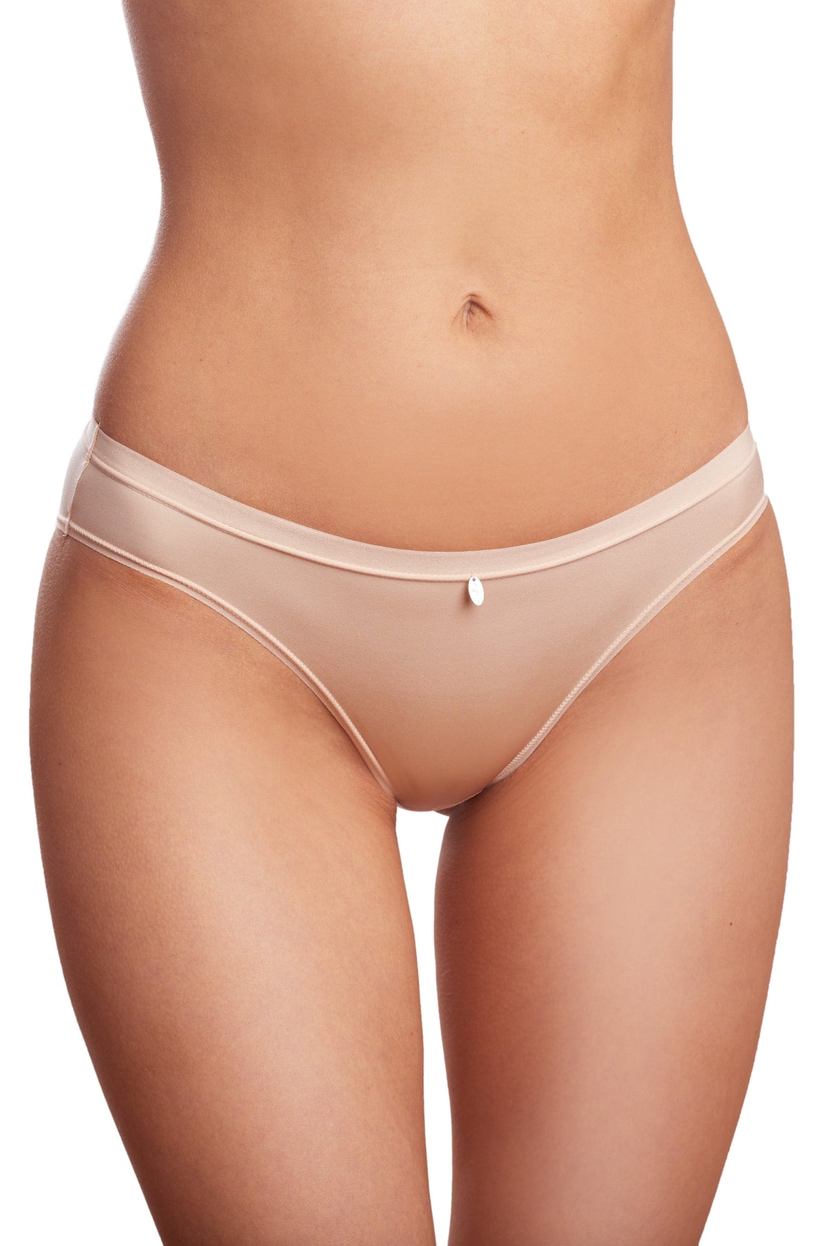 Beige bikini-cut underwear featuring a smooth seamless design with a small white metallic charm at the center of the waistband.