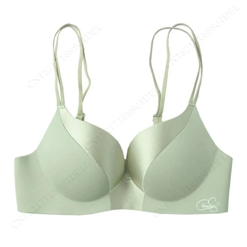 A sage green underwire bra features double spaghetti straps, molded cups, and a small white circular logo on the lower right band.