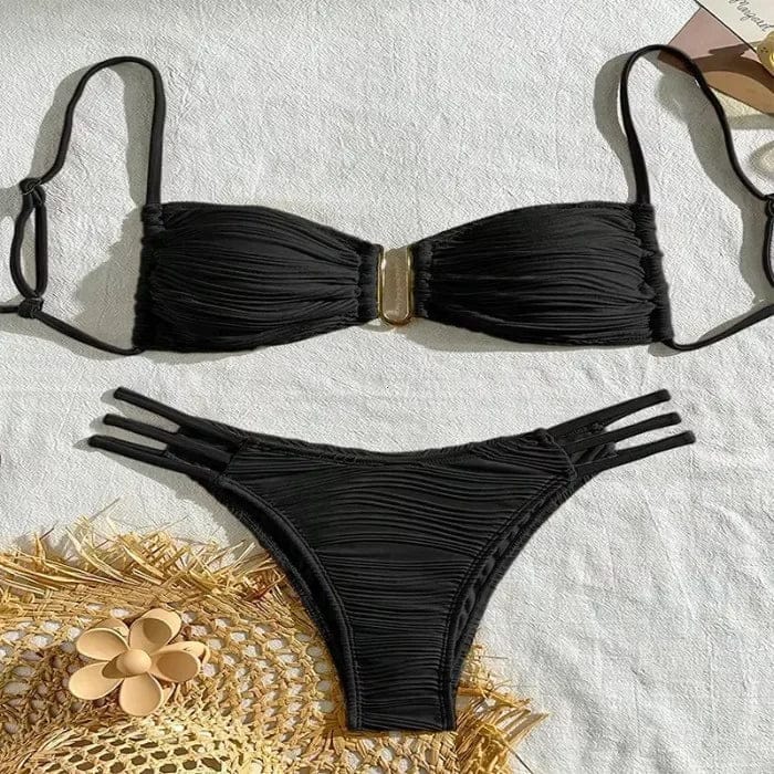 A black two-piece bikini set featuring a textured, ruched strapless top with a central gold-tone metal accent and matching bottoms with triple-strap side cutouts.