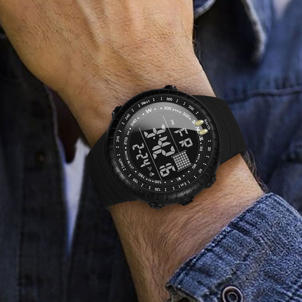 A black digital sports watch with a circular face and silicone strap worn on a person's wrist.