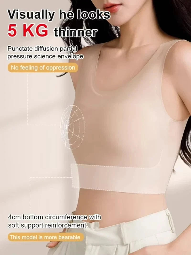A beige seamless crop top tank bra is worn by a person, featuring a thick bottom band and subtle structural pattern details on the chest.