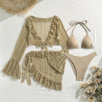 A beige three-piece swimsuit set featuring a triangle bikini top, high-cut bikini bottoms, and a long-sleeve, ruffled-edge sheer cover-up top and matching wrap skirt laid flat against a textured white background.