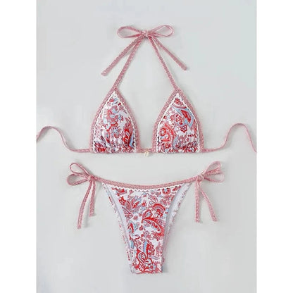 A two-piece bikini set with a vibrant red and blue paisley floral print, featuring a triangle top with tie-back straps and matching side-tie bikini bottoms.