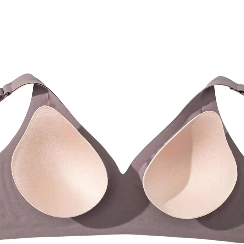 A taupe-colored wireless bra featuring a deep V-neckline with two integrated, beige teardrop-shaped foam cups against a plain white background.