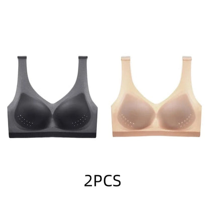 Two seamless sports bras with perforated padding, one in black and one in beige, displayed side by side against a white background.