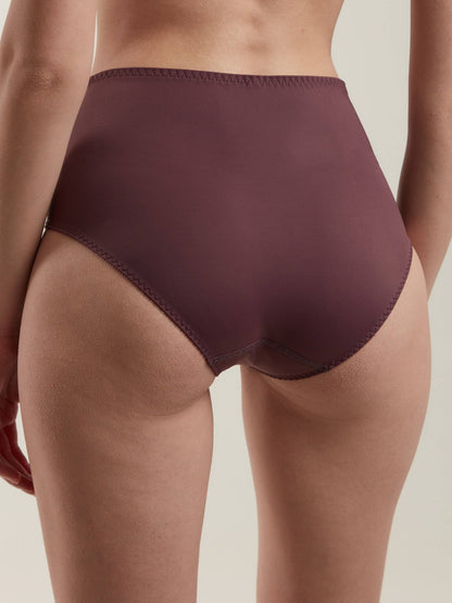 High-waisted briefs in a solid dark mauve color are worn by a person, shown from a rear perspective against a plain neutral background.