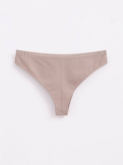 A pair of light brown thong panties with a decorative patterned trim along the waistband.