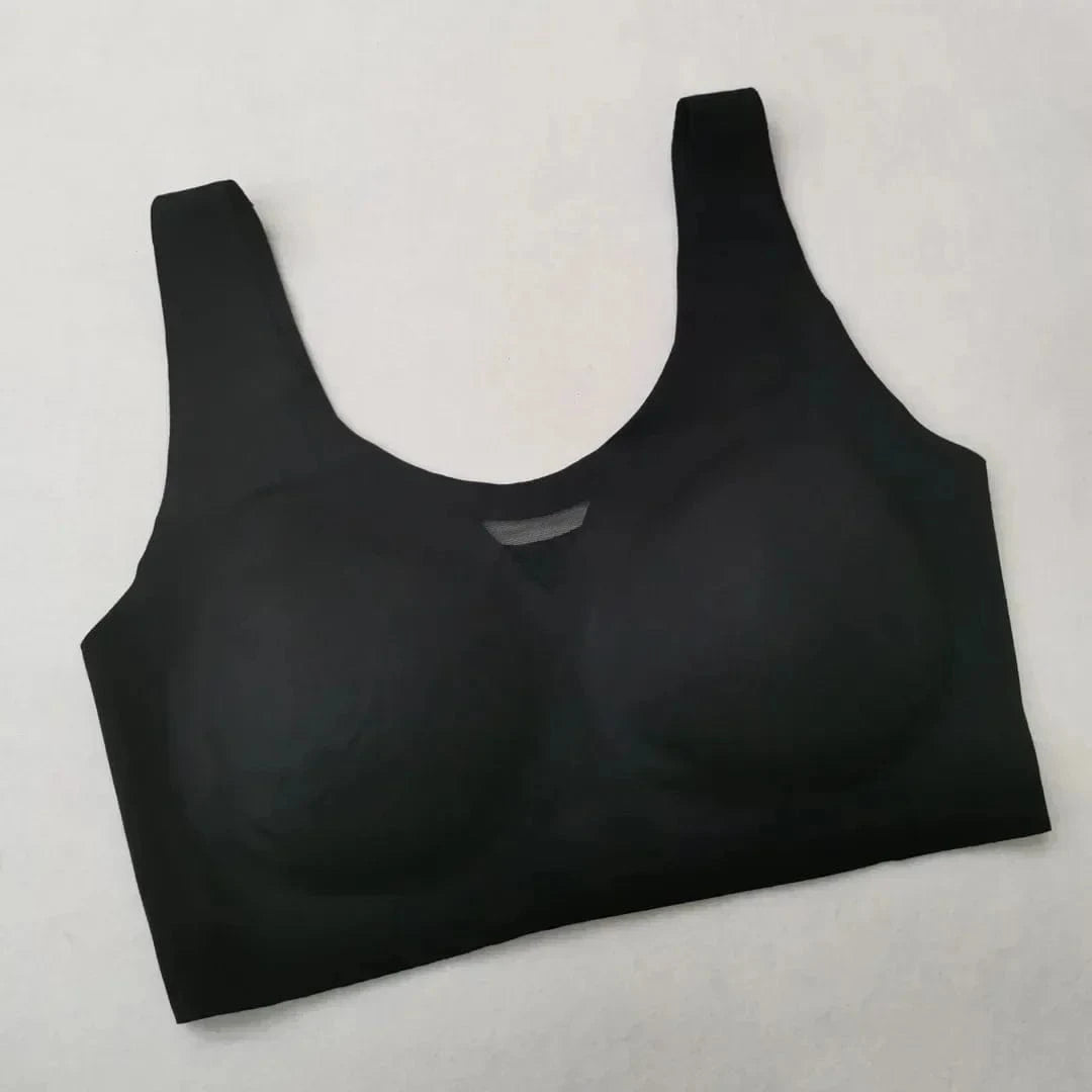 A black seamless scoop neck bralette with wide shoulder straps and a small mesh detail at the center neckline.