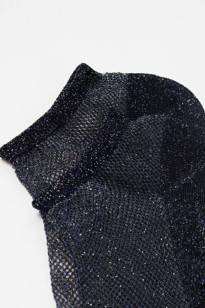 An ankle-length sock in a shimmering, dark blue and black open-knit mesh fabric.