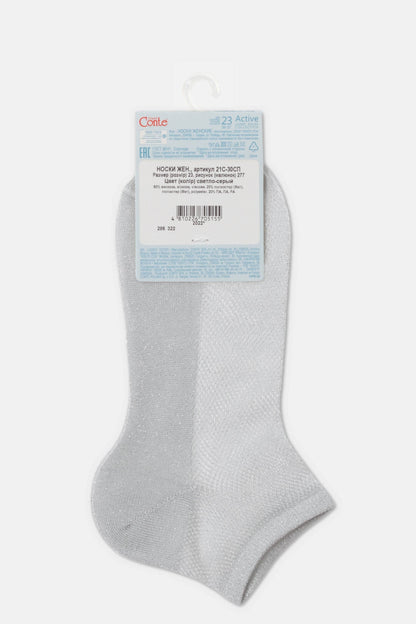 A pair of shimmering light grey ankle socks with a branded paper tag attached to the top against a plain white background.