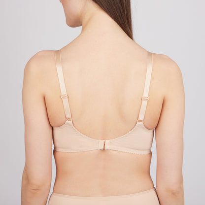 A beige bra shown from the back view, featuring adjustable shoulder straps and a central hook-and-eye closure.