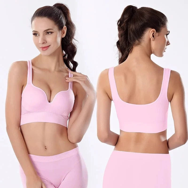 A light pink seamless sports bra shown from the front and back on a model against a white background.