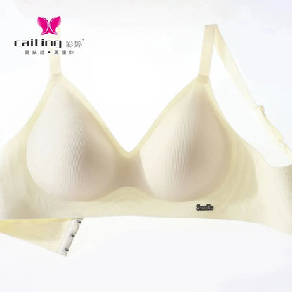 A beige wireless bra features ribbed fabric, thin adjustable shoulder straps, and a small metal "Smile" label on the lower front band against a white background.