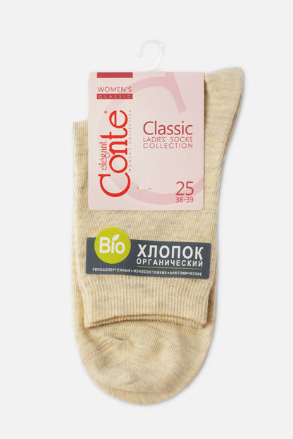 A pair of beige heathered socks folded on a white background with a large branded product tag attached at the top.