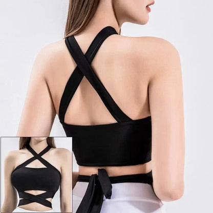 A black cropped athletic top with a crisscross halter neckline and a tie-back closure, shown from both the back and the front.