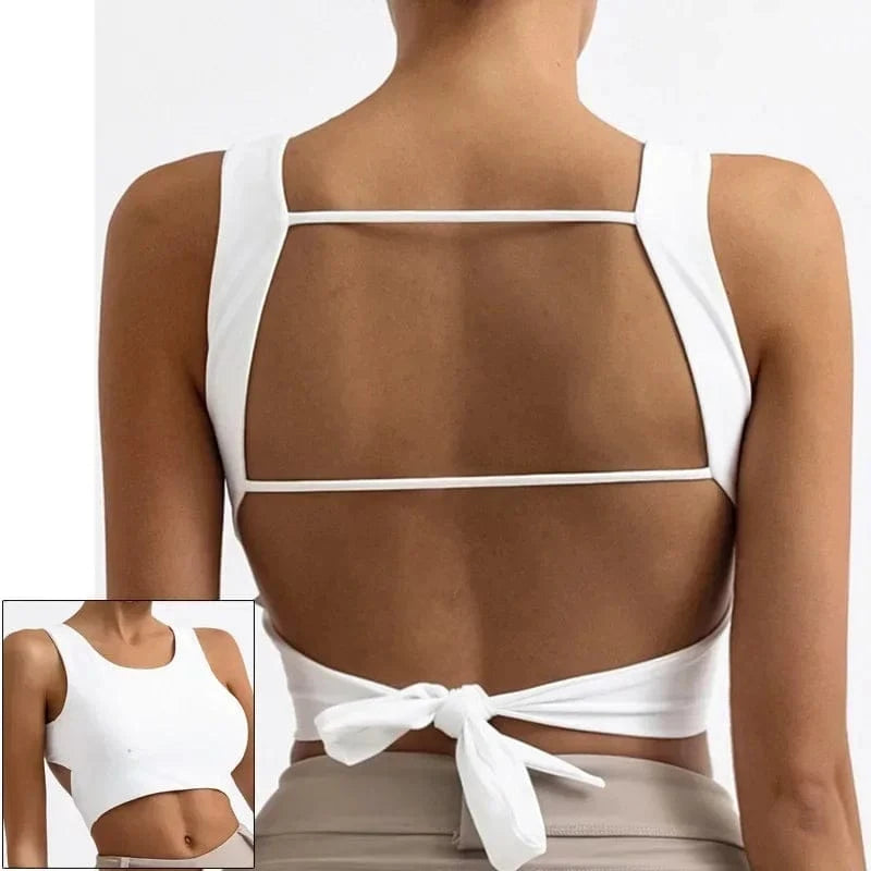 A white cropped tank top with an open back design featuring two horizontal straps across the back and a tie closure at the waist, shown from both the back and front views.