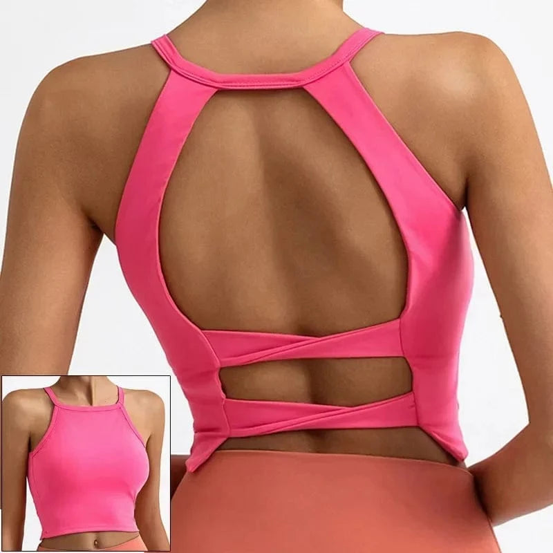 A bright pink cropped athletic tank top with a high neck and an open back featuring crisscross straps, shown from the back and in a small front-view inset.