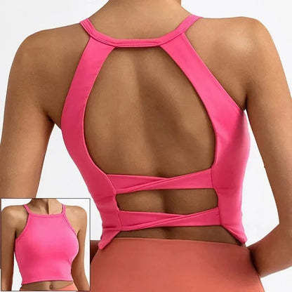 A bright pink cropped athletic tank top with a high neck and an open back featuring crisscross straps, shown from the back and in a small front-view inset.