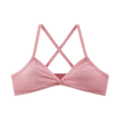 A light pink ribbed bralette featuring a deep V-neckline and crisscross shoulder straps.