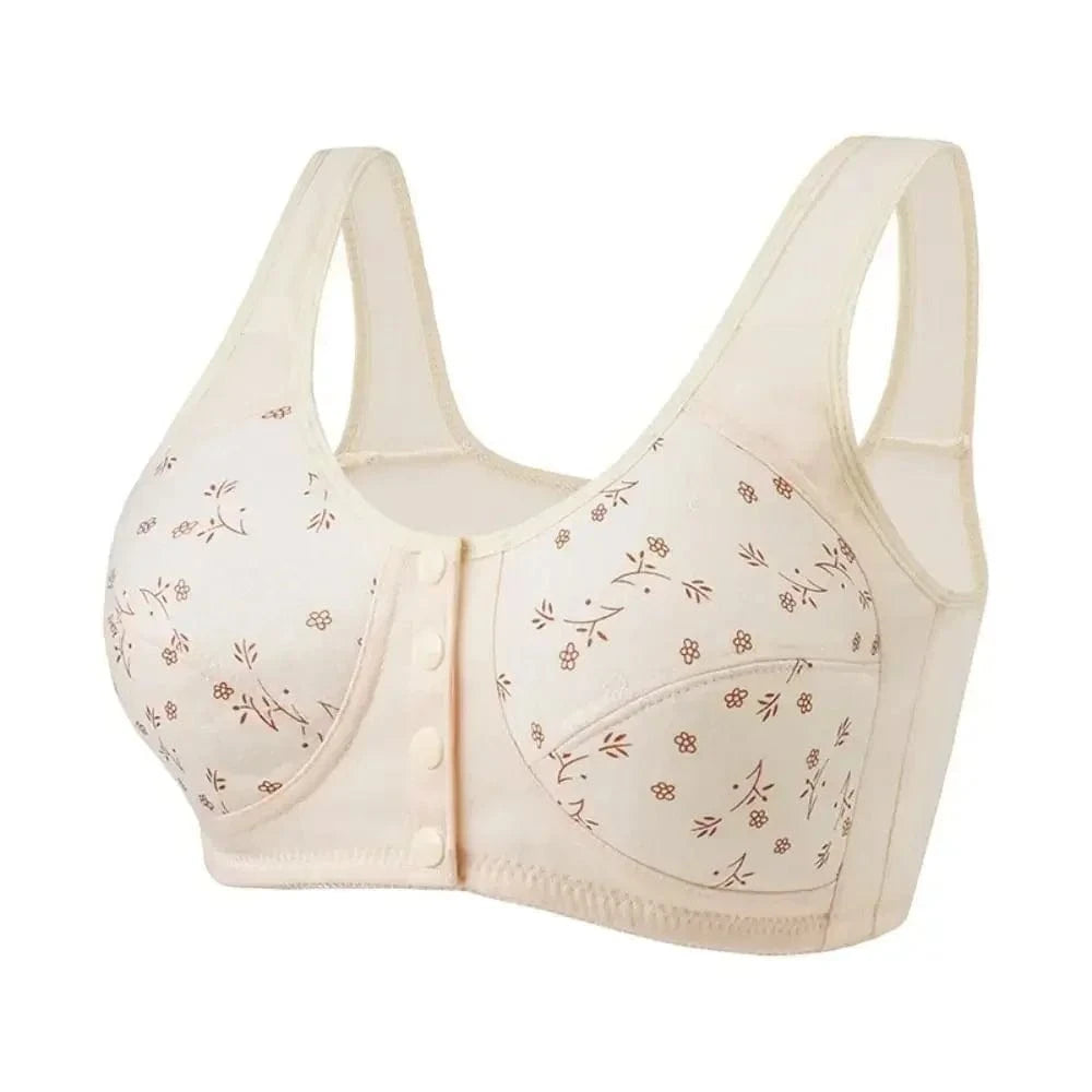 A beige front-closure bra features a delicate brown floral pattern and wide shoulder straps.