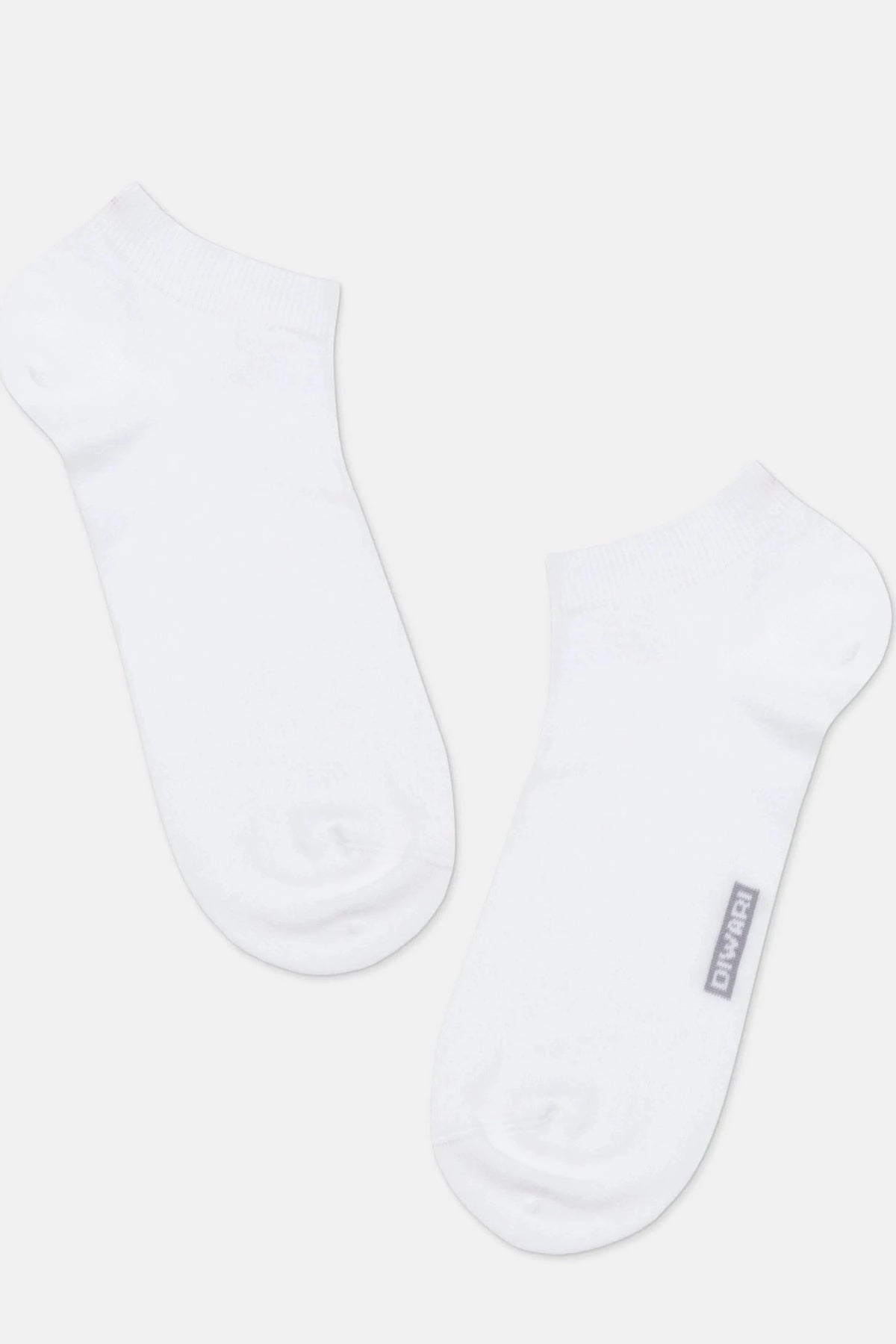 A pair of white ankle socks positioned diagonally against a plain light gray background, with the brand name printed in small gray text on the outer side of the right sock.