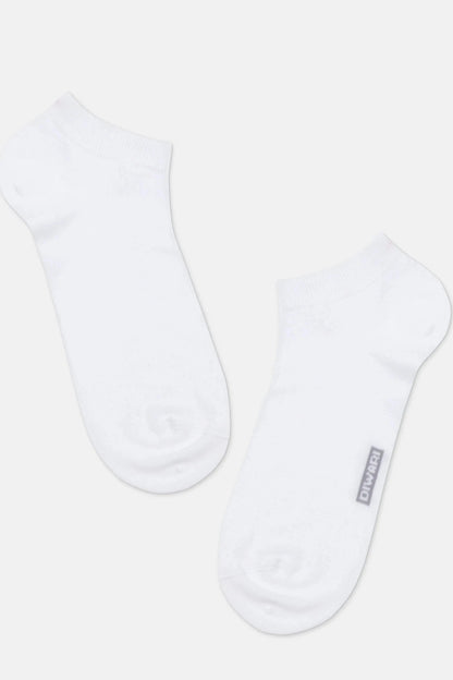 A pair of white ankle socks positioned diagonally against a plain light gray background, with the brand name printed in small gray text on the outer side of the right sock.