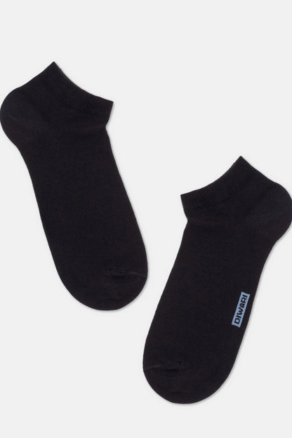 A pair of black ankle socks laid out on a light background, with a small blue logo tag visible on the side of one sock.