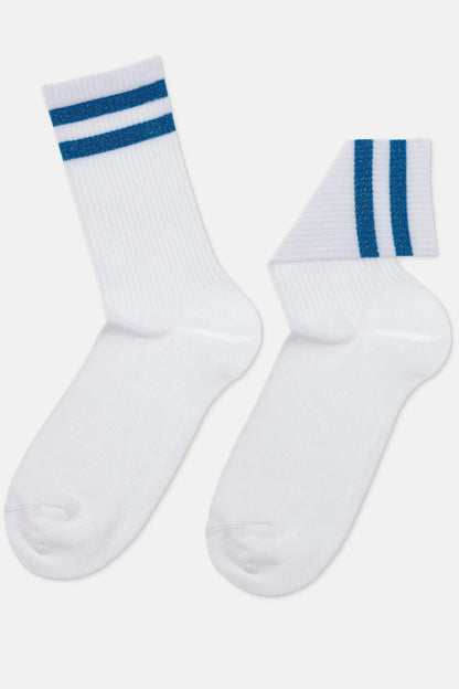 Two white crew socks with two horizontal blue glitter stripes at the ribbed cuff, displayed against a plain light gray background.