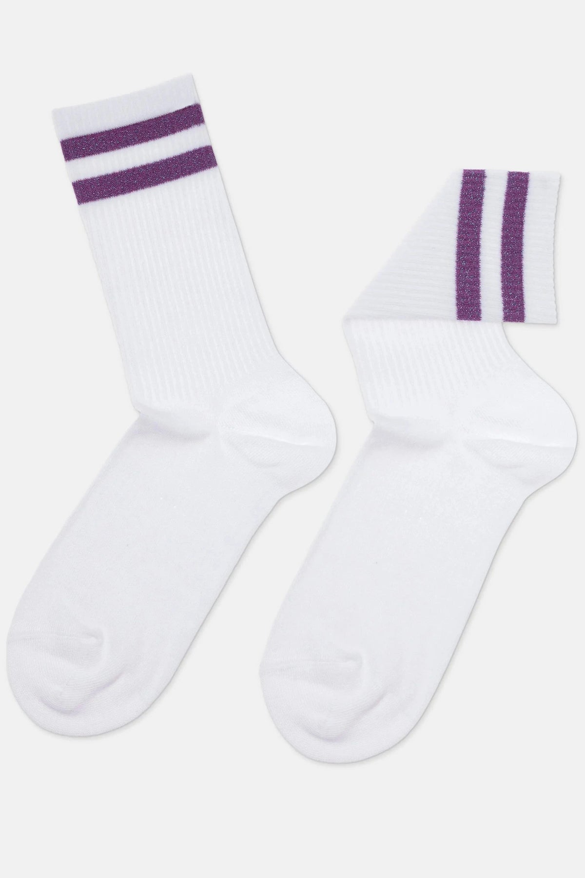 A pair of white crew socks features two horizontal shimmering purple stripes around the ribbed ankle cuffs.