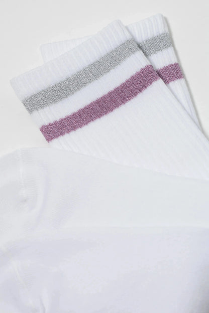 White crew socks feature a metallic silver stripe and a metallic pink stripe at the ribbed cuffs.