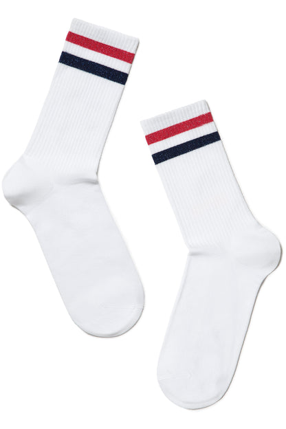 A pair of white crew-length socks featuring two horizontal stripes in red and navy blue at the top cuff.