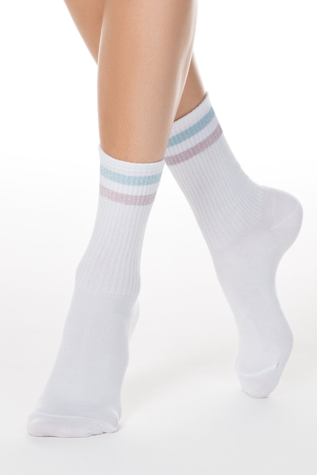 White crew socks featuring two horizontal metallic pastel stripes in light blue and pink around the ribbed cuffs, modeled on a person's legs against a white background.