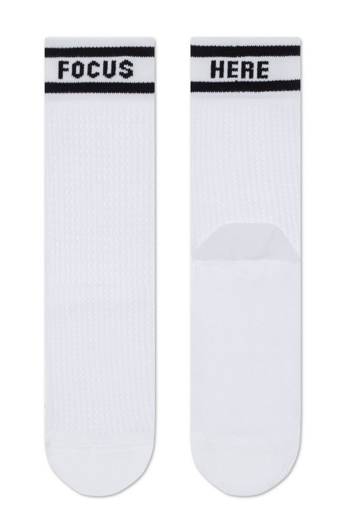 A pair of white mid-calf socks with black stripes at the top, featuring the word FOCUS printed on the left sock and the word HERE printed on the right sock.