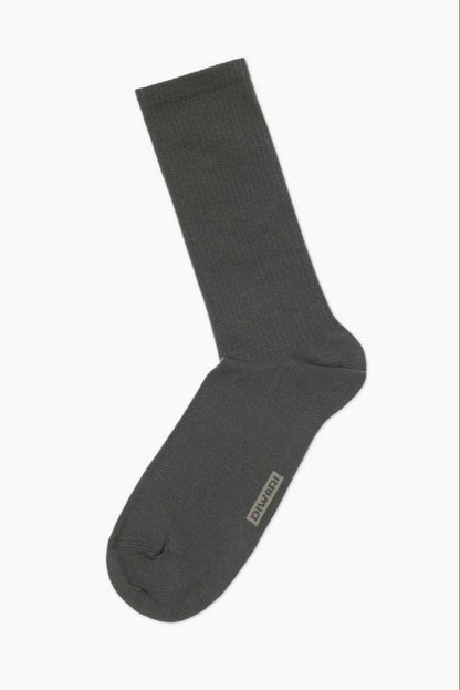 A single dark grey ribbed crew sock with a small grey brand logo on the side of the foot, isolated on a white background.