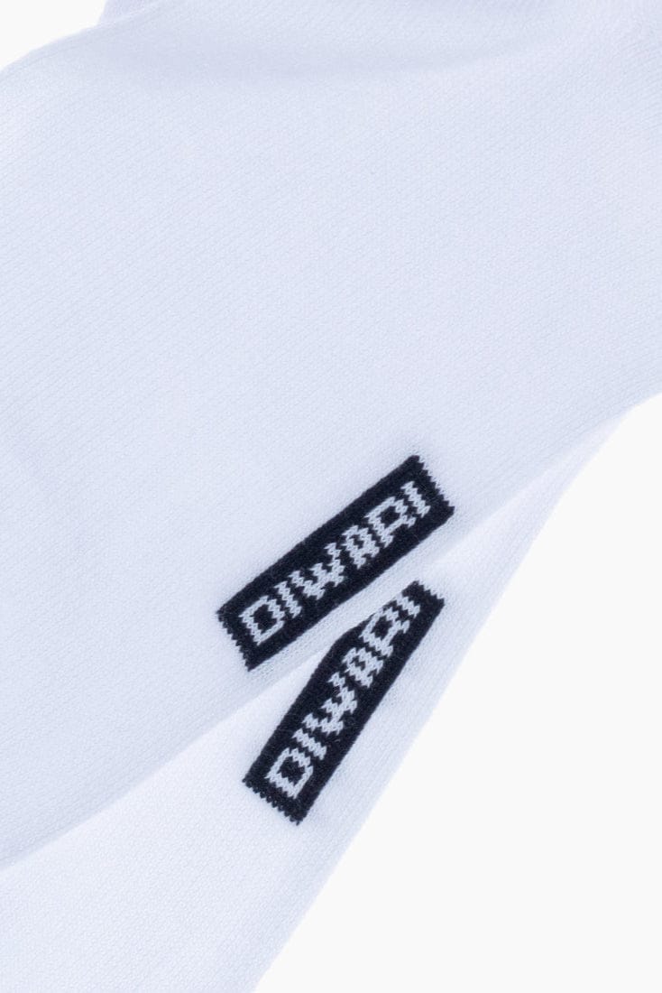 A pair of white crew socks features the black text DIWARI knitted into each side.
